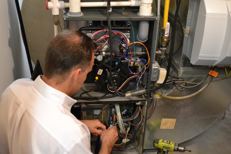 Larry & Sons technician servicing a furnace