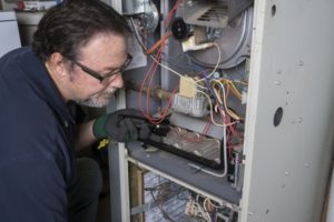 hvac tech working on a furnace 