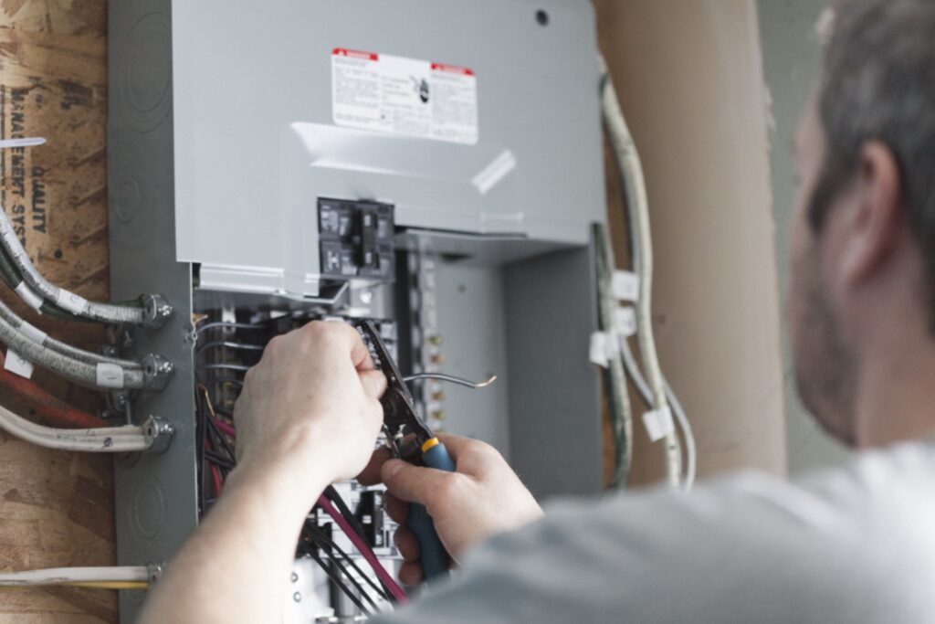 Electrician repairing circuit panel